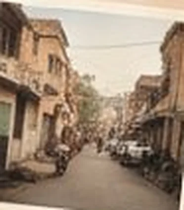 Quiet residential street with balconies and parked bikes