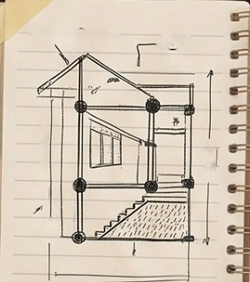 Hand-drawn sketch of a house section in a spiral notebook