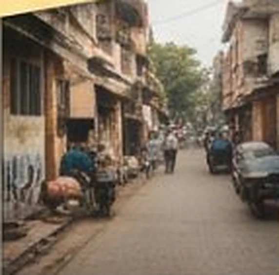 Busy residential street with shops and scooters
